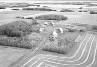Aerial photograph of a farm near Marcelin, SK (45-7-W3)