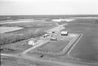 Aerial photograph of a farm near Cleeves, SK (52-21-W3)