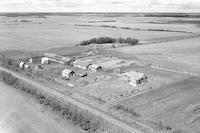 Aerial photograph of a farm near Meadow Lake, SK (60-18-W3)