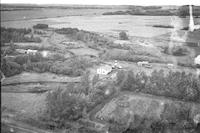 Aerial photograph of a farm near Meadow Lake, SK (60-17-W3)