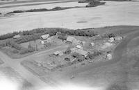 Aerial photograph of a farm near Radisson, SK (42-9-W3)