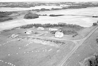 Aerial photograph of a farm near Meadow Lake, SK (60-17-W3)