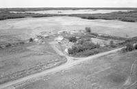 Aerial photograph of a farm near Meadow Lake, SK (60-18-W3)