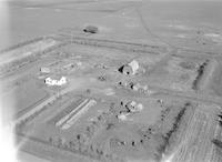 Aerial photograph of a farm near Meadow Lake, SK (58-17-W3)