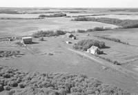 Aerial photograph of a farm near Meadow Lake, SK (60-18-W3)