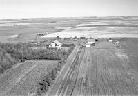 Aerial photograph of a farm near Macklin, SK (39-28-W3)