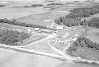 Aerial photograph of a farm near Hafford, SK (42-9-W3)