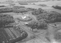 Aerial photograph of a farm near Meadow Lake, SK (50-18-W3)